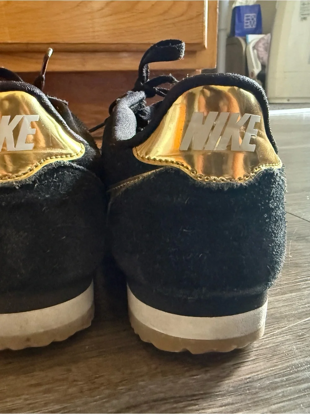 Nike Men’s Black Suede Sneakers with Gold Swoosh